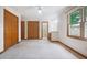 Spacious bedroom with natural light, neutral carpet, ensuite bathroom, and ample closet space at 4611 29Th St, Columbus, IN 47203