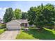 Charming single-story home featuring a well-maintained lawn, attached garage, and mature shade tree at 4611 29Th St, Columbus, IN 47203