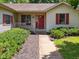 Home's entrance featuring a quaint porch and walkway framed by meticulous landscaping at 4611 29Th St, Columbus, IN 47203