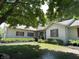 Traditional home with a covered front porch, shutters, landscaping, and green lawn at 4611 29Th St, Columbus, IN 47203