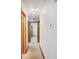 Clean hallway with carpeted floors and neutral paint leads to the bedrooms at 4611 29Th St, Columbus, IN 47203