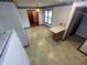 Eat-in kitchen with floral wallpaper border, cream cabinets, and tiled floor at 4611 29Th St, Columbus, IN 47203