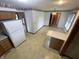 Eat-in kitchen with floral wallpaper border, cream cabinets, and tiled floor at 4611 29Th St, Columbus, IN 47203