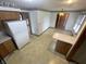 Eat-in kitchen with floral wallpaper border, cream cabinets, and tiled floor at 4611 29Th St, Columbus, IN 47203