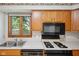 Close-up on the kitchen sink and countertop with natural light from the exterior window at 4611 29Th St, Columbus, IN 47203