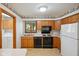 Traditional kitchen featuring wood cabinets, black appliances, and a bright window for natural light at 4611 29Th St, Columbus, IN 47203