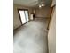 Open living room with vaulted ceilings, fireplace, ceiling fan, and carpet flooring at 4611 29Th St, Columbus, IN 47203