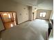 Bright living room featuring neutral carpet, large windows, and ceiling fan at 4611 29Th St, Columbus, IN 47203