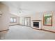 Spacious living room features carpeted floors, a fireplace, vaulted ceilings and lots of natural light at 4611 29Th St, Columbus, IN 47203