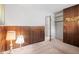 Bedroom showcasing wood-paneled walls, neutral carpet, and a closet for ample storage space at 4864 N Katherine Dr, Indianapolis, IN 46226