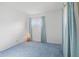 Bright bedroom with soft blue carpet, a window, and neutral-colored walls at 4864 N Katherine Dr, Indianapolis, IN 46226