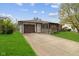 Front exterior view with stone accents, showing the driveway, garage, and the front entrance at 4864 N Katherine Dr, Indianapolis, IN 46226