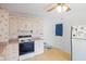 Classic kitchen features white cabinets, standard appliances, and a door leading to the outside at 4864 N Katherine Dr, Indianapolis, IN 46226