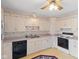 Cozy kitchen with white cabinetry, standard appliances, and neutral countertops and a ceiling fan at 4864 N Katherine Dr, Indianapolis, IN 46226