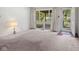 Spacious living room featuring a large window with natural light and neutral-toned carpet at 4864 N Katherine Dr, Indianapolis, IN 46226