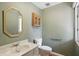 Well-maintained half-bath features vanity sink, mirror, and a wall cabinet at 5177 Fairway Dr, Avon, IN 46123