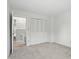 Neutrally-decorated bedroom includes carpet and closet near stairs at 5177 Fairway Dr, Avon, IN 46123