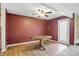 Dining room with wood floors, chandelier fan, and a white trimmed glass door at 5177 Fairway Dr, Avon, IN 46123