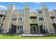 Back exterior of a multi-story townhome with balconies, multiple windows and private patios at 5177 Fairway Dr, Avon, IN 46123