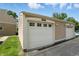 Exterior view showcasing a well-maintained garage with attached unit numbers and lush surrounding greenery at 5177 Fairway Dr, Avon, IN 46123
