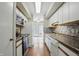 Well-lit kitchen with stainless steel appliances and wood floors at 5177 Fairway Dr, Avon, IN 46123