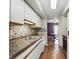 Galley kitchen with white cabinets, stainless steel appliances, and modern backsplash at 5177 Fairway Dr, Avon, IN 46123