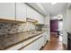 Updated kitchen features sleek countertops, stainless steel sink, and tile backsplash at 5177 Fairway Dr, Avon, IN 46123