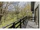 View from the black wood balcony showing the wooded landscape beyond at 5190 Potters Pike, Indianapolis, IN 46234