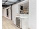 Elegant bar area featuring modern cabinetry, a wine fridge, and stylish views into the kitchen at 5190 Potters Pike, Indianapolis, IN 46234