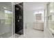Modern bathroom with glass shower, black tile accent wall, and vanity at 5190 Potters Pike, Indianapolis, IN 46234
