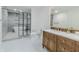 Beautiful bathroom with wood vanity, backlit mirror, and tiled shower with tub at 5190 Potters Pike, Indianapolis, IN 46234