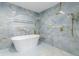 Tiled shower with built-in niche features a freestanding tub at 5190 Potters Pike, Indianapolis, IN 46234