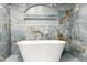 Bathroom features gorgeous blue tilework, a soaking tub, and an arched shelf at 5190 Potters Pike, Indianapolis, IN 46234
