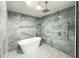 Tiled shower features rainfall shower head and a freestanding tub at 5190 Potters Pike, Indianapolis, IN 46234