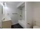 Modern bathroom with vanity, toilet, and tub-shower combo featuring designer tile and gold fixtures at 5190 Potters Pike, Indianapolis, IN 46234