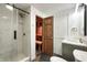 Modern bathroom features a steam shower, sauna, gray vanity and gold fixtures at 5190 Potters Pike, Indianapolis, IN 46234