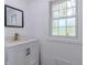 Bathroom with a vanity, mirror, and frosted window at 5190 Potters Pike, Indianapolis, IN 46234