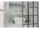 Tiled shower features a freestanding tub and a glass enclosure at 5190 Potters Pike, Indianapolis, IN 46234
