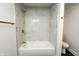 Bright bathroom featuring a modern bathtub with stylish marble tile surround and gold fixtures at 5190 Potters Pike, Indianapolis, IN 46234