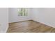 Empty bedroom with hardwood floors, window and neutral walls at 5190 Potters Pike, Indianapolis, IN 46234