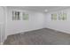 Spacious bedroom boasts plush gray carpeting and two windows offering ample natural light at 5190 Potters Pike, Indianapolis, IN 46234