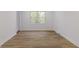 Bright bedroom featuring light wood floors, neutral walls, and natural light from the double window at 5190 Potters Pike, Indianapolis, IN 46234
