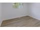 Bright bedroom featuring light wood floors, neutral walls, and natural light from the double window at 5190 Potters Pike, Indianapolis, IN 46234