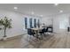 Dining room features wood table, six chairs, a patterned rug, and three windows with view at 5190 Potters Pike, Indianapolis, IN 46234