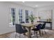 Modern dining room featuring stylish decor, a wood dining table, and an area rug at 5190 Potters Pike, Indianapolis, IN 46234