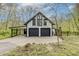 Exterior of home with black and white color scheme, two-car garage and lean-to structure at 5190 Potters Pike, Indianapolis, IN 46234