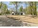 Charming home with a driveway winding through mature trees at 5190 Potters Pike, Indianapolis, IN 46234