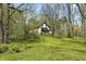 View of house on grassy hill in woods at 5190 Potters Pike, Indianapolis, IN 46234