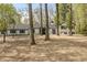 Beautiful home with a manicured lawn and a peaceful, wooded backdrop at 5190 Potters Pike, Indianapolis, IN 46234