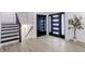 Welcoming foyer with modern light-colored flooring, staircase, and black front door at 5190 Potters Pike, Indianapolis, IN 46234